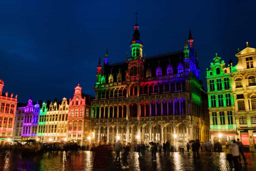 Brussels Grand Place at night and its multi colour show of lights red, orange, yellow, green blue, and violet.