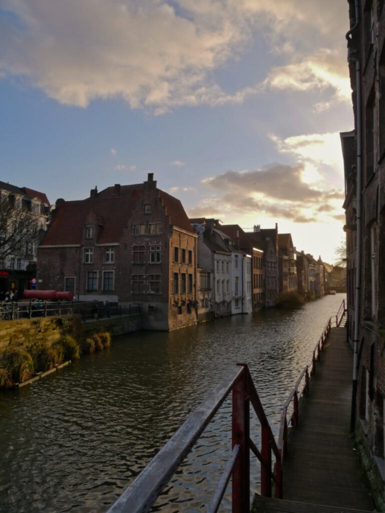 Photo of a sun-kissed Leie river in Ghent.