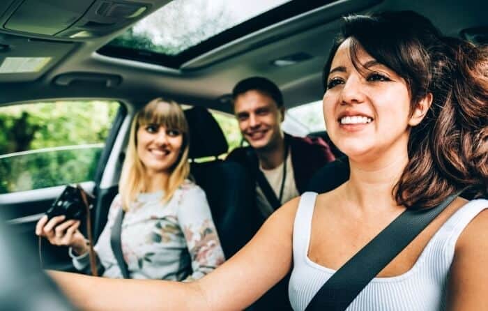 A group of tourists in their rented car.