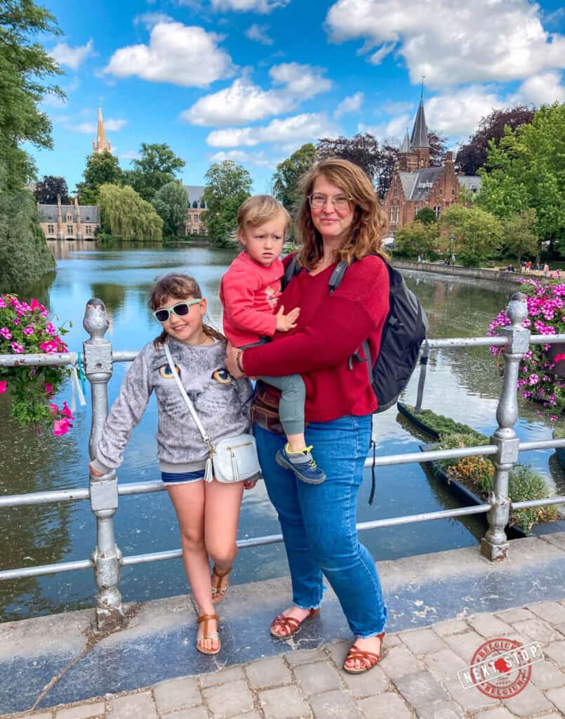 Mom with two kids with the view of Bruges Minnewater Park at the back.