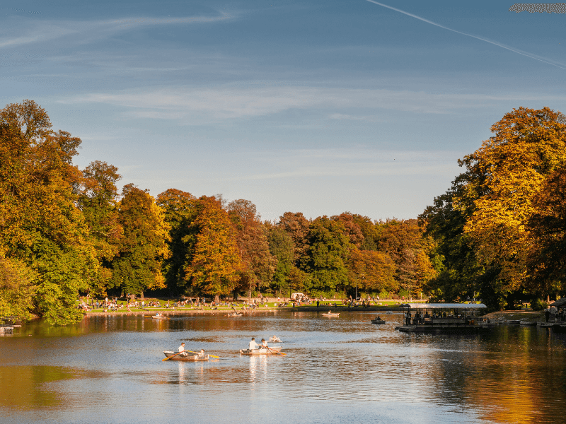 The Bois de la Cambre with yellow green trees and calm waters.