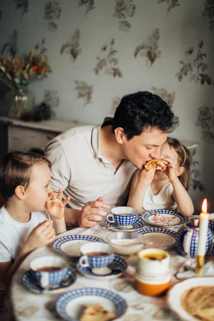 Father eats breakfast with children