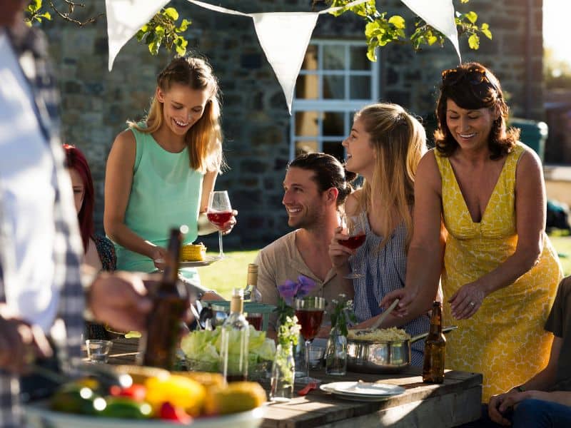 people smiling and looking happy during outside lunch