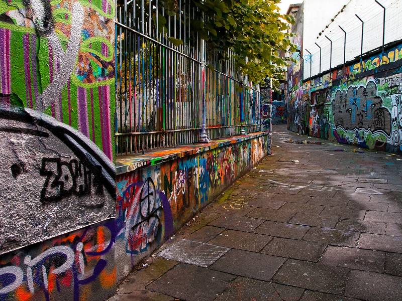 Colorful graffiti on a street wall in Ghent.