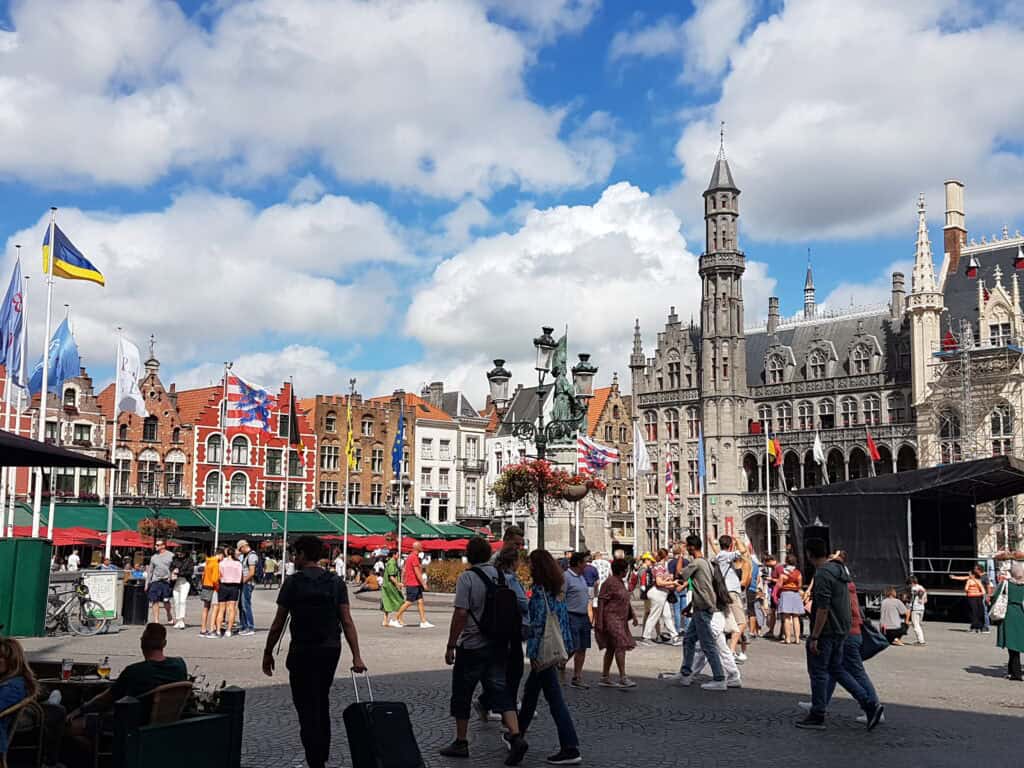 A vibrant display of things to do in Bruges where locals and tourists enjoy leisurely strolls at the Bruges Central Market
