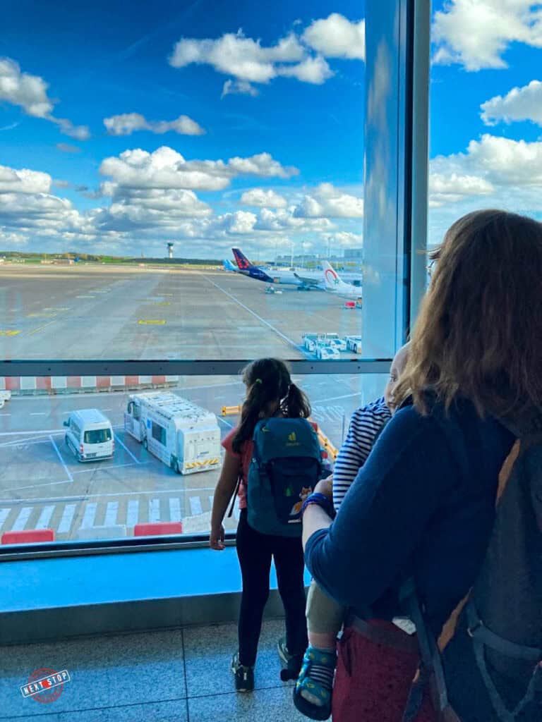 Babs and N looking out of the window towards the planes.