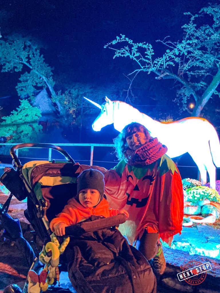 kids in front of a unicorn light statue