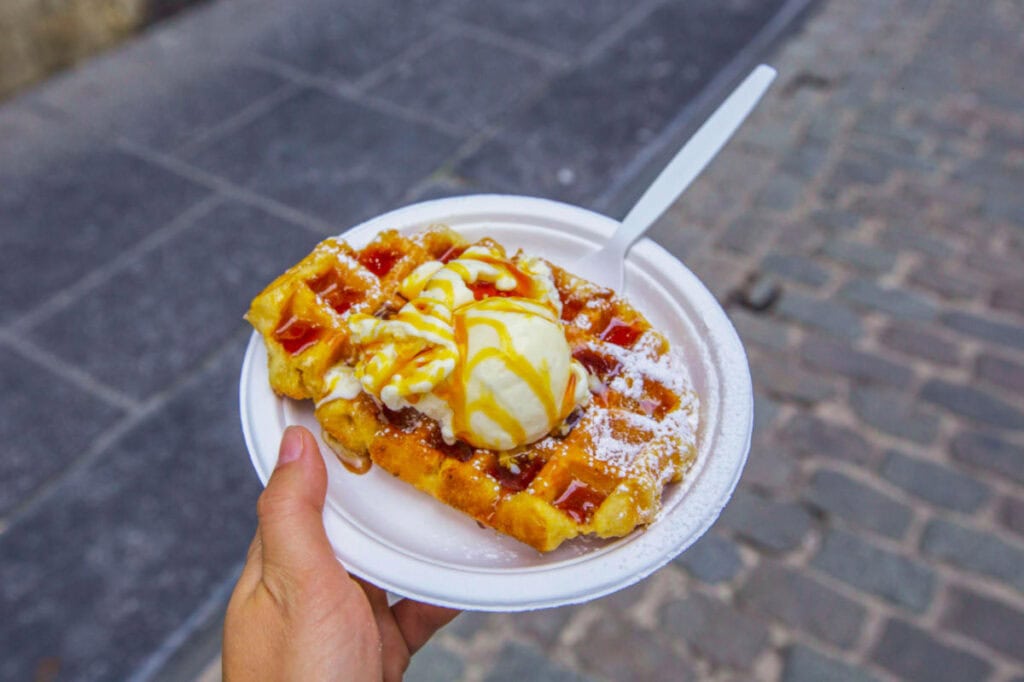 Belgian waffles topped with ice cream.