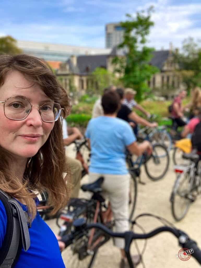 Portret of Babs with the group of cyclists at the back in one of the Antwerp bike tours.