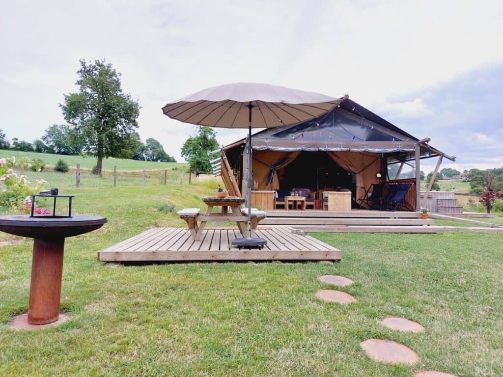 Exterior of La Relais D'Artagnan featuring a traditional building in a rural setting with green surroundings.