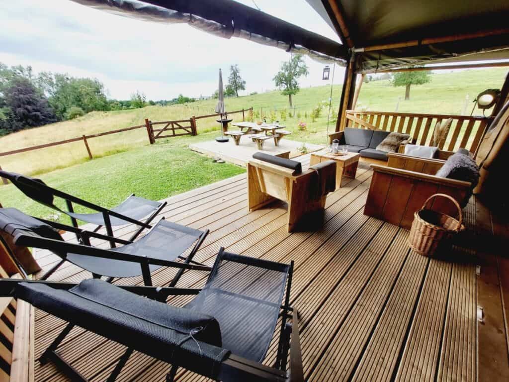 Outdoor view of La Relais D'Artagnan showcasing a picturesque countryside estate with classic architectural designs surrounded by lush greenery and rolling fields.