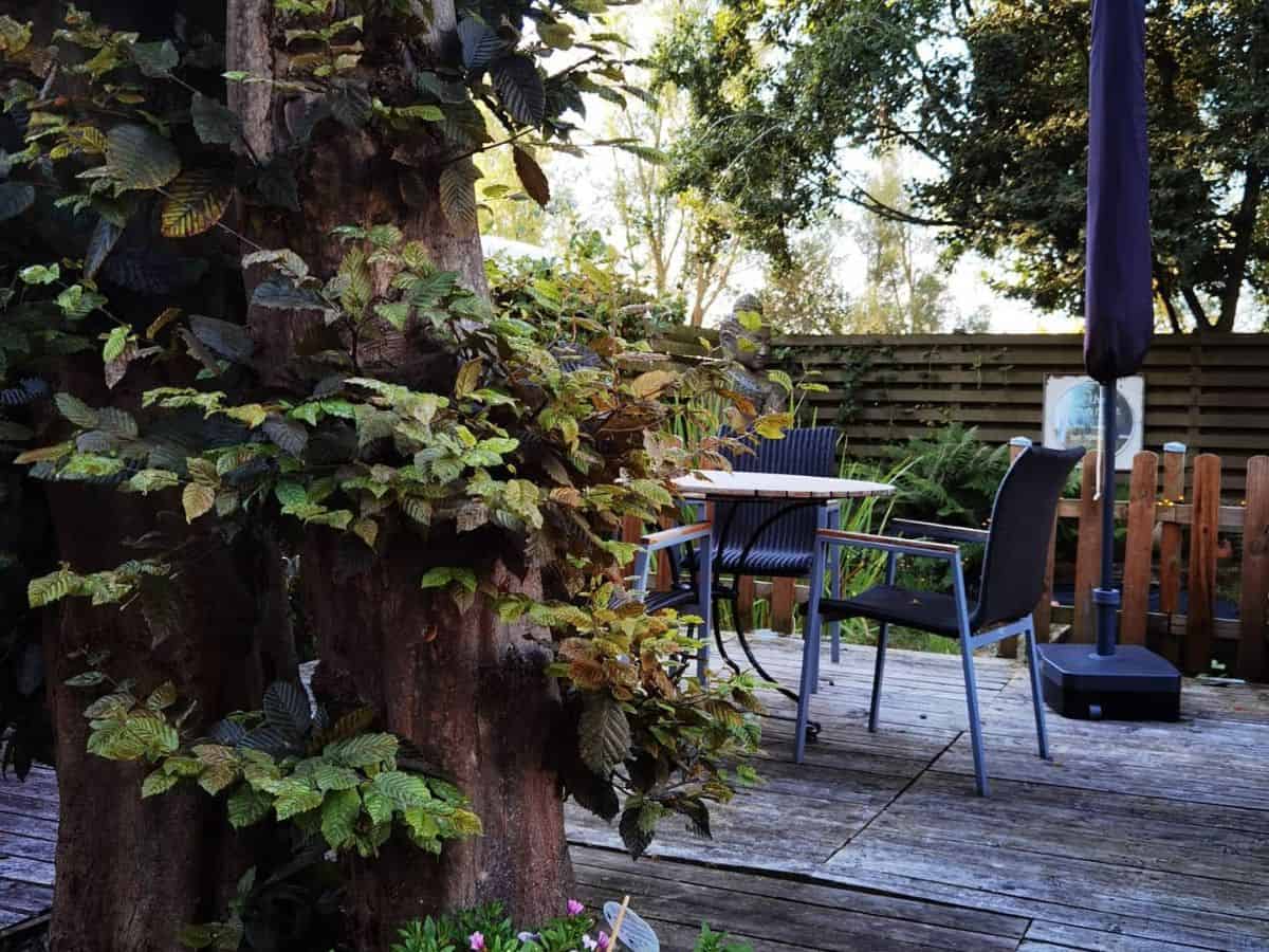 Relaxing outdoor scene at Glamping Universe, featuring comfortable seating areas amidst a serene natural landscape.