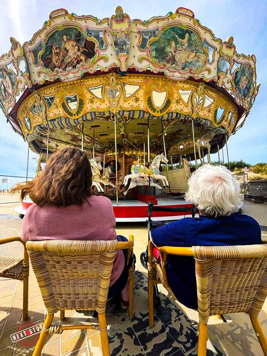 Me and my grandma sitting in a chair watching the old carousel.