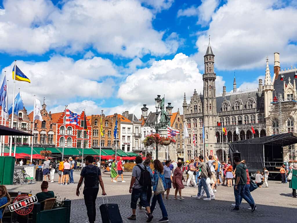 Busy central market in Bruges filled with people.