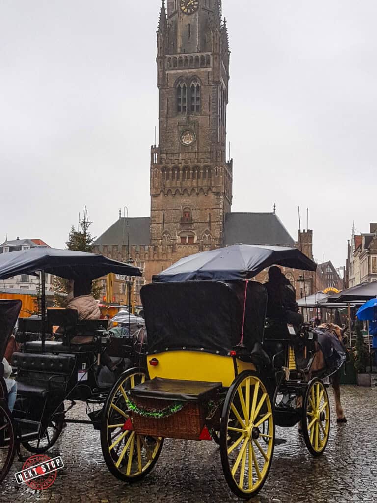 Horses and carriages in Bruges as the rain pours.