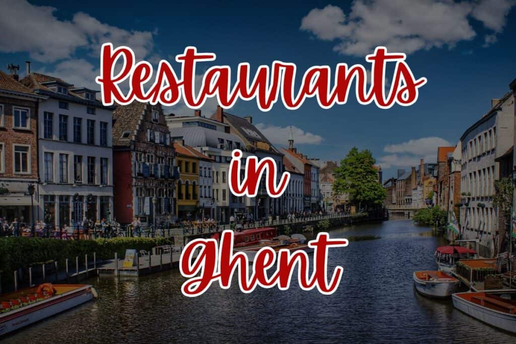 Colorful row houses line the Leie River in Ghent under a bright blue sky, with small boats docked along the water and people dining outside by the canal. Bold red script over the image reads “Restaurants in Ghent.”