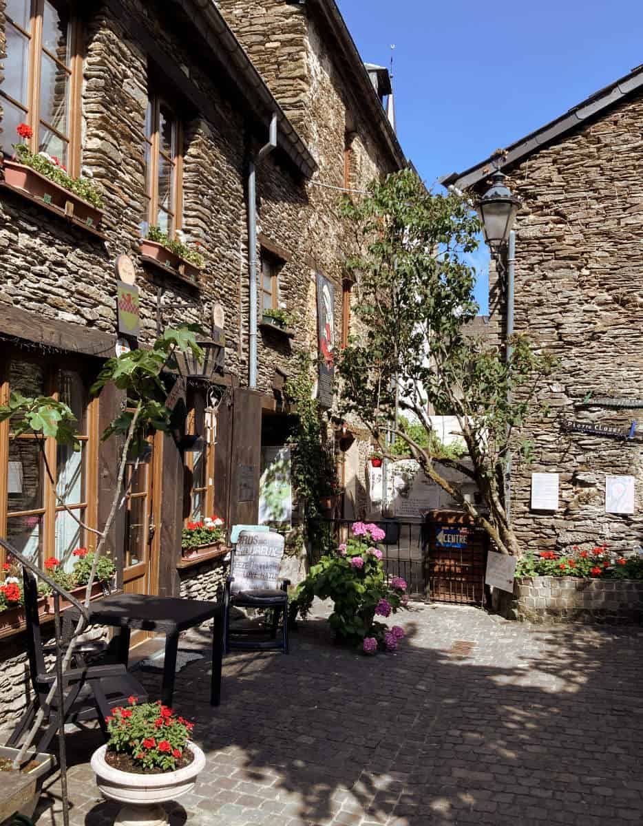 A view of a charming, narrow cobblestone courtyard in the streets of Bouillon.